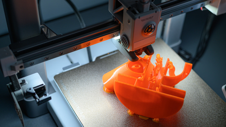 3D printer working on a single orange object