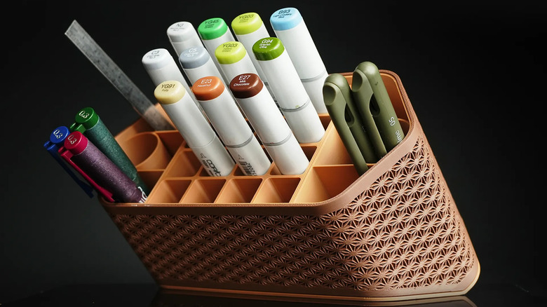 Module pen holder containing multiple pens, markers, and a ruler