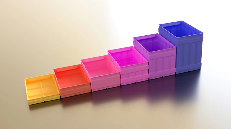 3D printed storage bins lined up next to each other in multiple colors