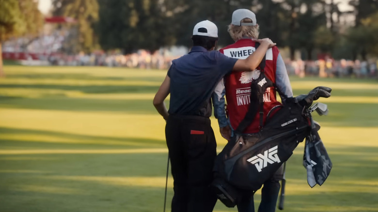 Owen Wilson as Pryce Cahill and Peter Dager as Santi in a golf tournament