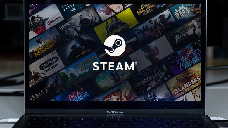 Laptop showing Steam logo and videogame titles