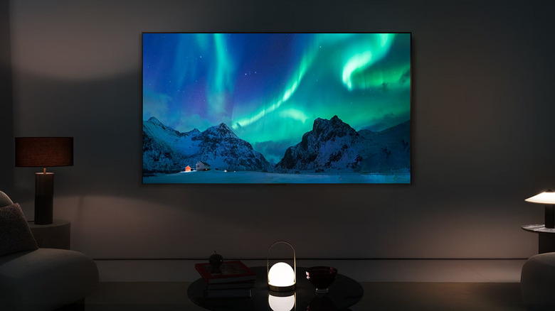 The LG C4 wall-mounted in a dim living room