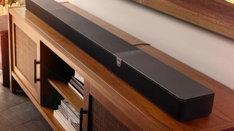 The Klipsch Flexus Core 300 soundbar on top of a wooden entertainment center