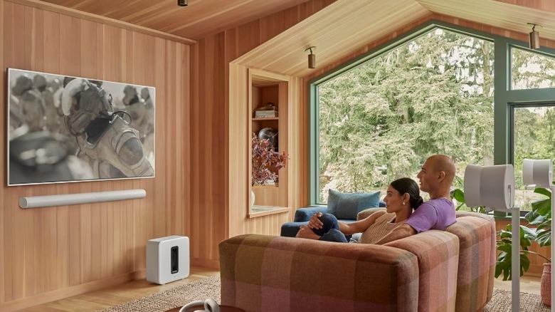A man and woman watching TV with Sonos Arc Ultra soundbar