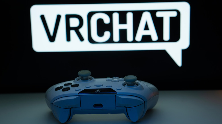 Game controller in the foreground with VRChat logo in the background