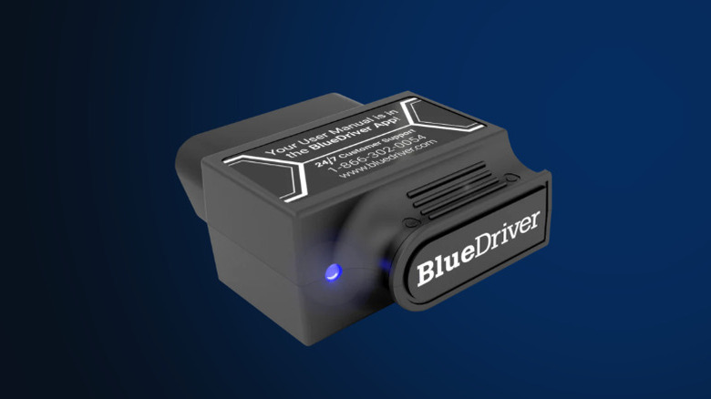 Man inserting BlueDriver Pro OBDII Scan Tool into car OBDII slot
