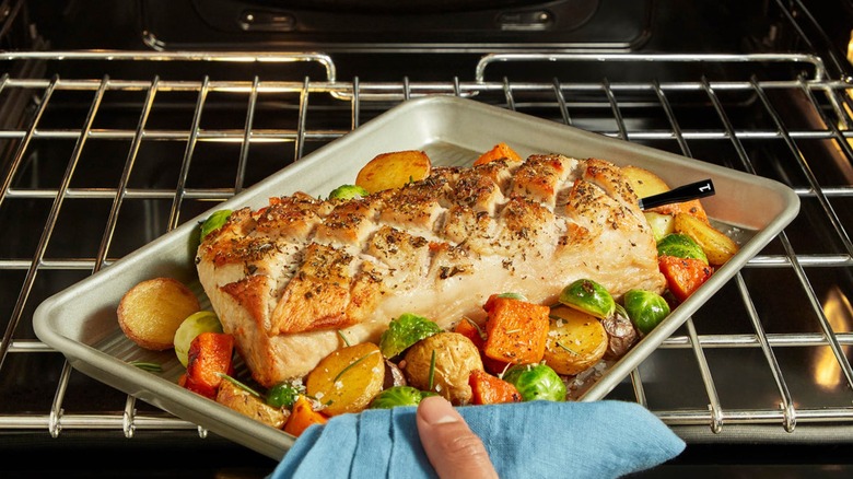 Person cooking fish with Chef iQ Sense thermometer probe