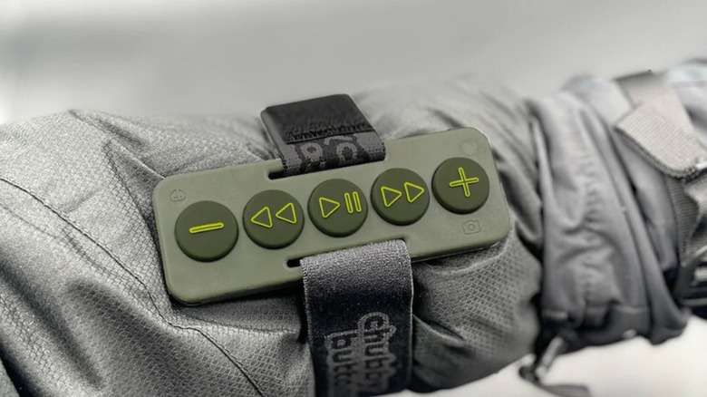 Person wearing Chubby Buttons over leather jacket