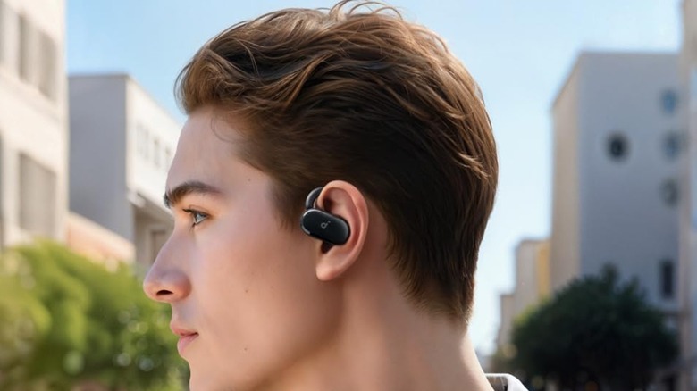 A person wearing the Anker Soundcore V20i open-ear earbuds.
