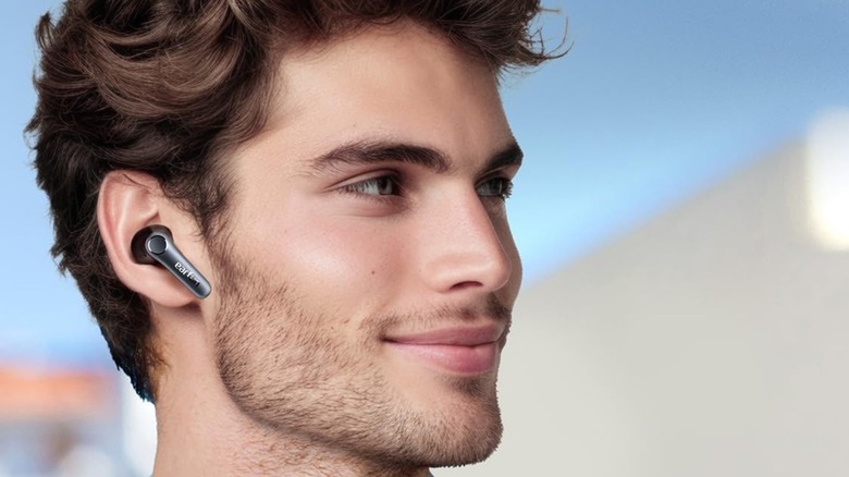 A person wearing the EarFun Air Pro 4 wireless earbuds.