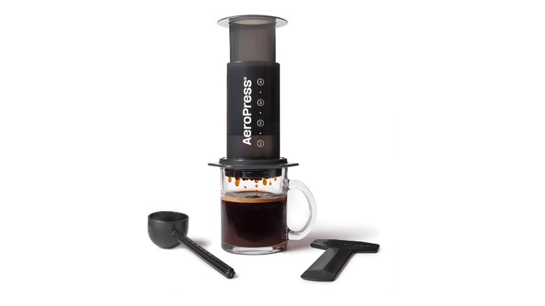 AeroPress coffee press machine pouring coffee in a cup