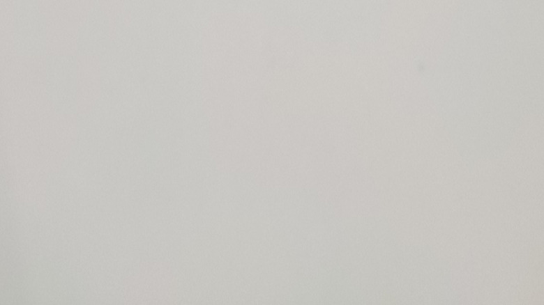 A close-up shot of a rechargeable keychain light with a USB cable