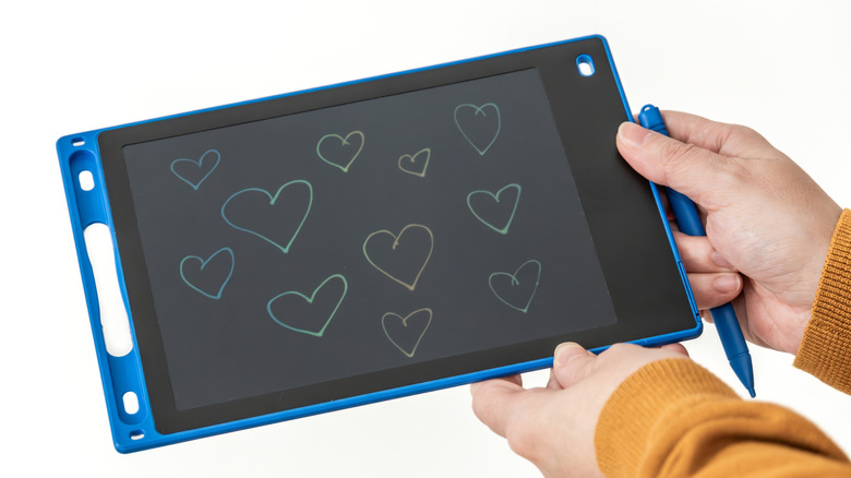 Someone holding a smart notebook and a pen