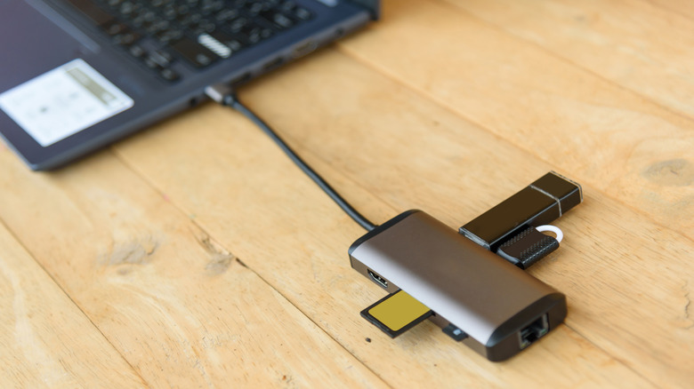 USB-C adapter connected to a laptop on a wooden table