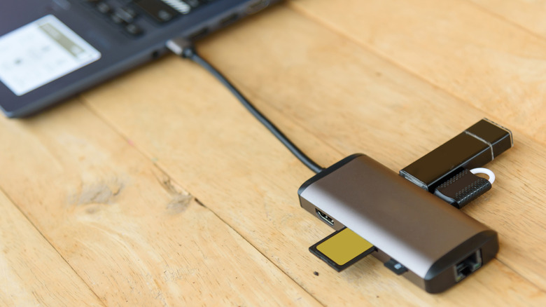 USB-C adapter connected to a laptop on a wooden table