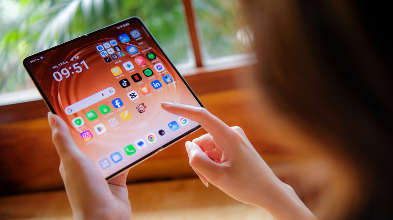 Closeup of a person using the inner screen of the Oppo Find N6