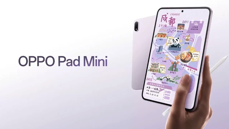 A person holding the Oppo Pad Mini with stylus