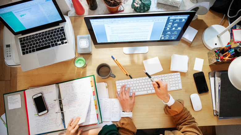 A top view of a cluttered desk in a home office.
