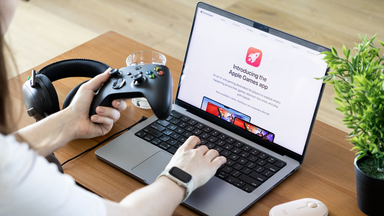 Apple Games app presented on MacBook Pro, used with Xbox controller, Logitech mouse, showing modern gaming experience