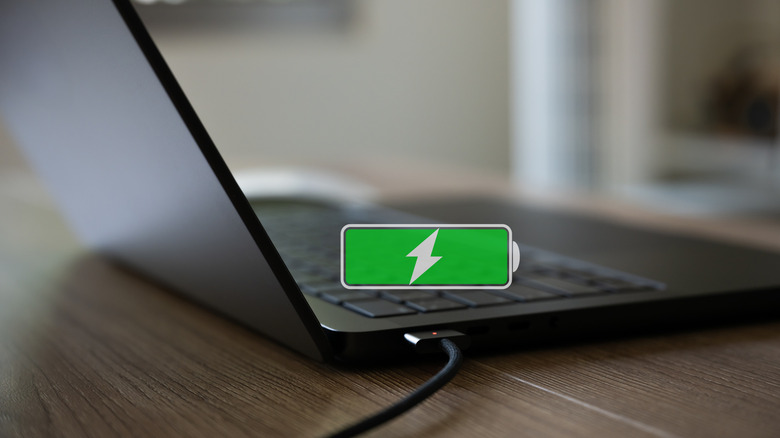 MacBook plugged in with full charging indicator