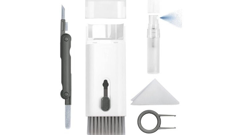 A product render of the Walrfrid 7-in-1 Cleaner kit. The render shows the sponge, brush, cloth, spray, keycap puller, and a microfiber cloth.