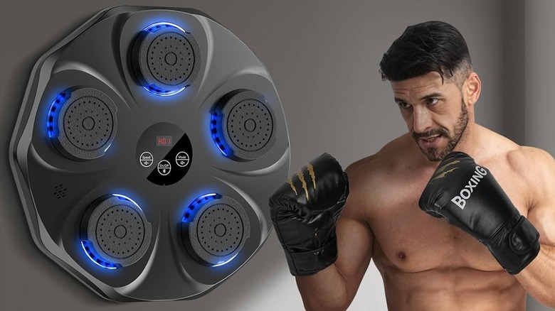 A man wearing boxing gloves about to use the TGLLM Music Boxing Machine.