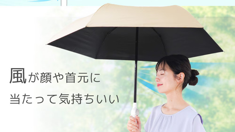 A woman standing underneath the fanbrella with the aiflow visualized