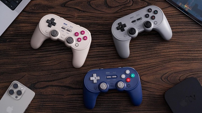 The three variants of the 8BitDo Pro 3 controller, placed on a table