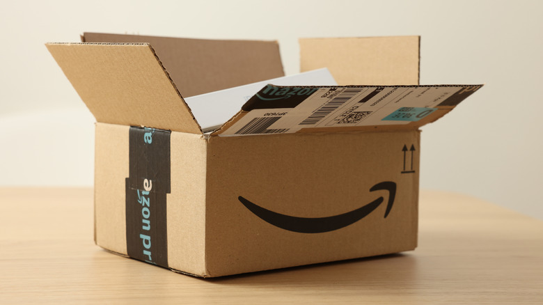 An opened Amazon box on top of a table.