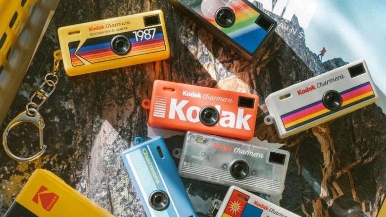 The different variants of the Kodak Charmera, placed on a wooden surface.