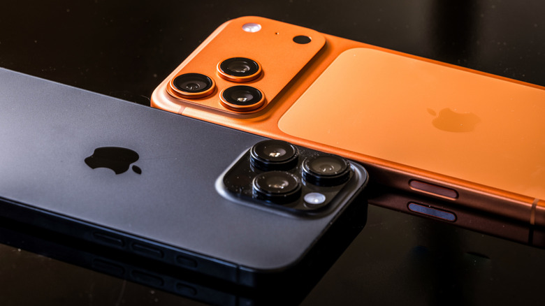 iPhone 17 Pro in Cosmic Orange and iPhone 16 Pro in Black placed side by side