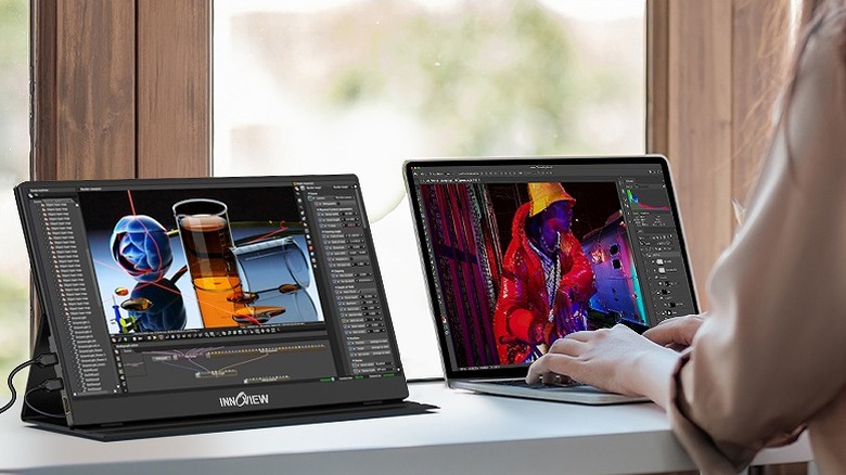 Portable monitor beside a laptop used for video editing