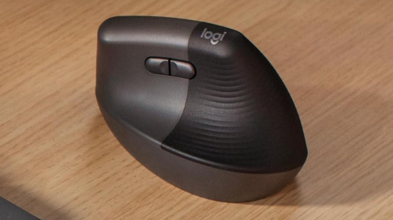 The Logitech Lift vertical wireless mouse on a wooden desk.