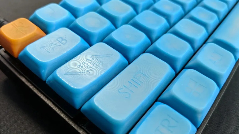 A close up photo of a 3D printed keycap set in light blue color.