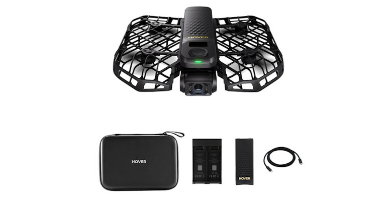 HoverAir ProMax drone above the carrying case, charging hub, and cables