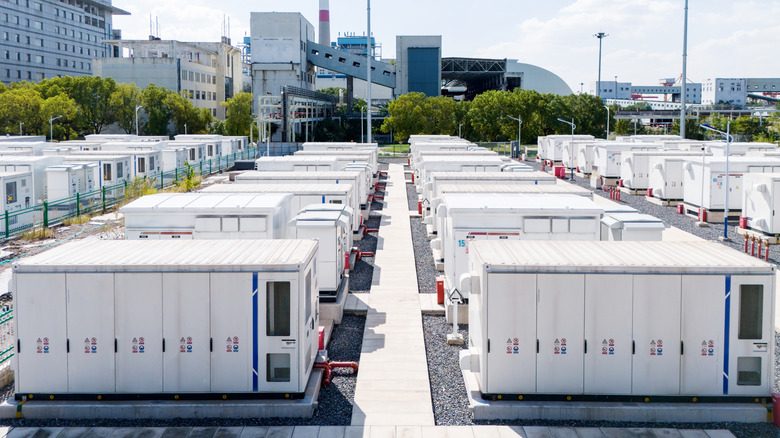 A large-scale industrial battery energy storage facility with rows of container-sized units.