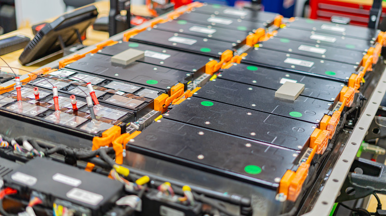 An exposed electric vehicle battery pack, showing the modular cells and high-voltage connectors used in modern EV platforms.