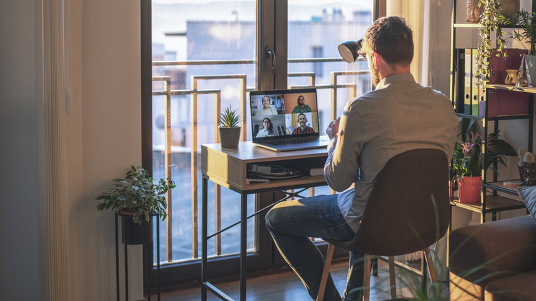 Remote worker using video conferencing app for meeting.