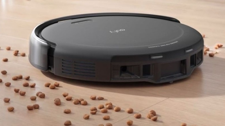 The Eufy C10 robot vacuum surrounded by dog food