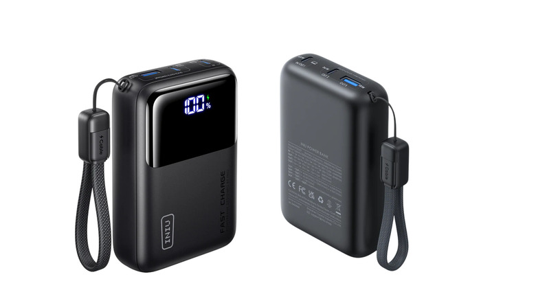 Front and back views of a compact black portable power bank with a digital battery display, USB ports, and an attached carrying strap.