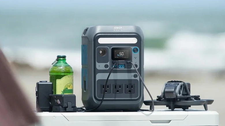 An image of the Anker Solix C300 portable power station charging a drone and external batteries.