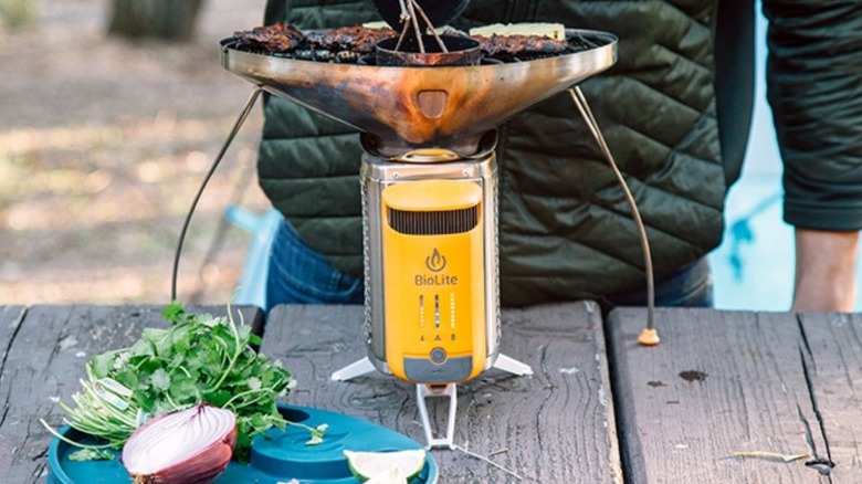 A person cooking dinner on top of the Biolite Campstove 2+