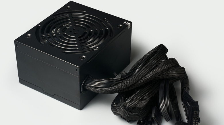 A black desktop power supply unit (PSU) with sleeved cables.