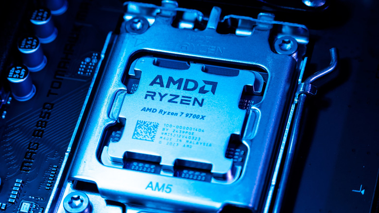 A close-up of the AMD Ryzen 7 9700X desktop CPU installed in a motherboard.