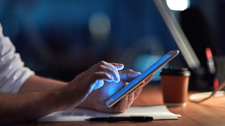 An individual holding an iPad