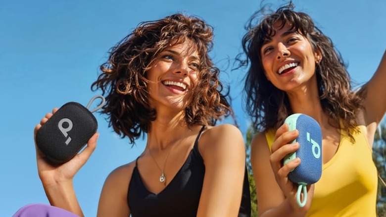 Two units of the Soundcore Select 4 Go Bluetooth speaker, held by women.