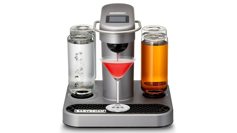 The Bartesian 55300 cocktail maker on a white background with its bottles filled, making a drink.