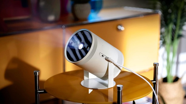 The Samsung The Freestyle portable projector in use, placed on a surface.
