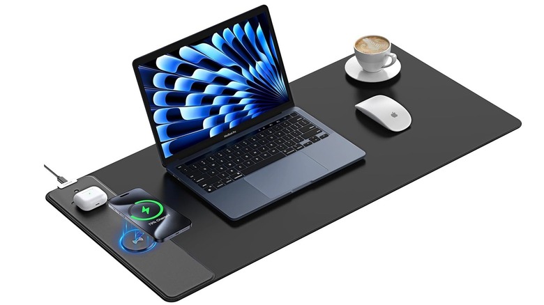 The TopMade 15W Wireless Charging XXL Large Mouse Pad on a desk, with a laptop and mouse while charging wireless earbuds and a phone