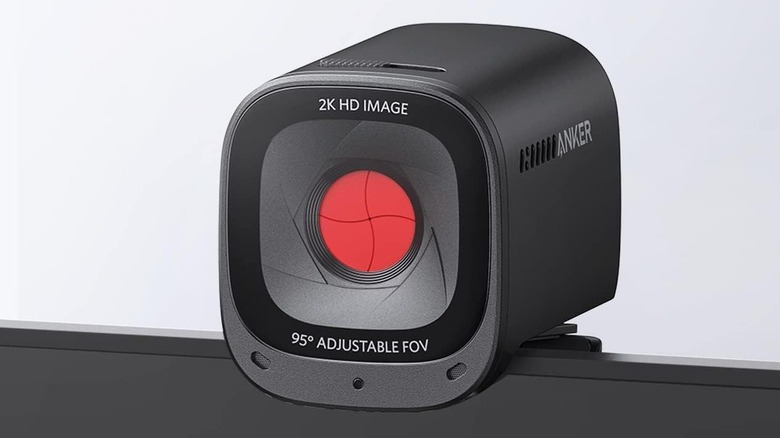 The Anker PowerConf C200 2K Webcam on top of a monitor with its privacy shutter closed